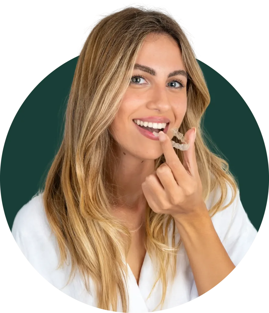 Woman inserting clear Invisalign aligner for teeth straightening at Loudoun Family & Cosmetic Dentistry in Leesburg, VA