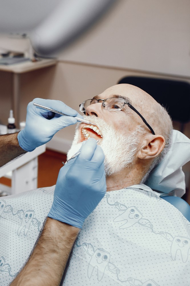 Male patient receiving professional dental cleaning at Loudoun Family & Cosmetic Dentistry in Leesburg, VA Male patient receiving professional dental cleaning at Loudoun Family & Cosmetic Dentistry in Leesburg, VA